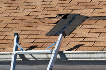 Picture of residential roof with shingles and ladder in Cheyenne Wyoming.